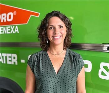 Woman standing in front of SERVPRO Fleet 